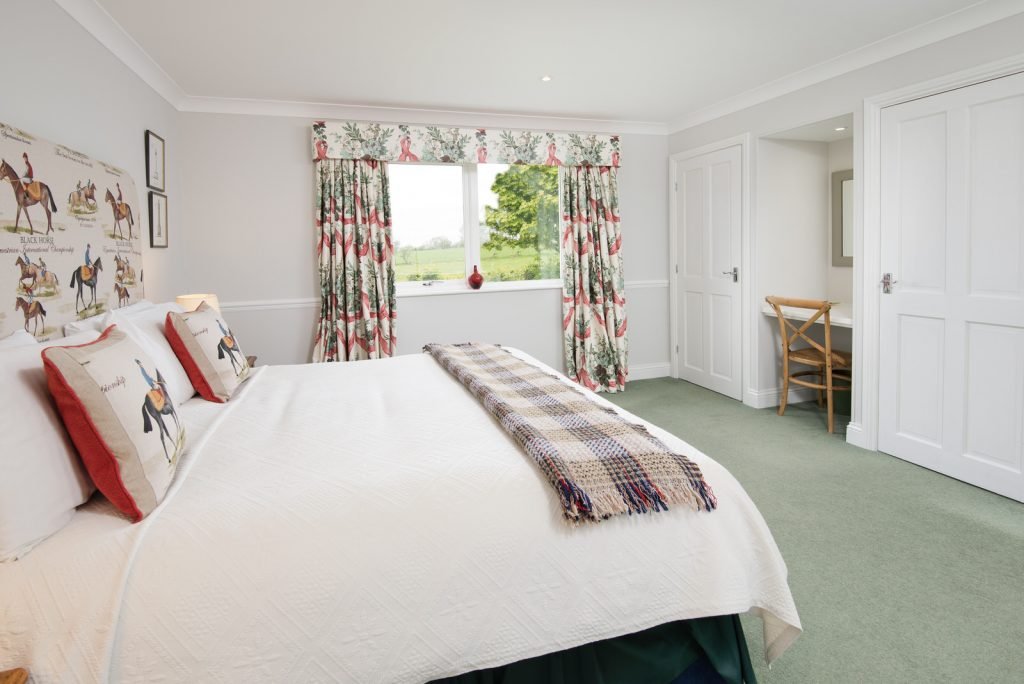 Cosy bedroom with elegant decor and window view.