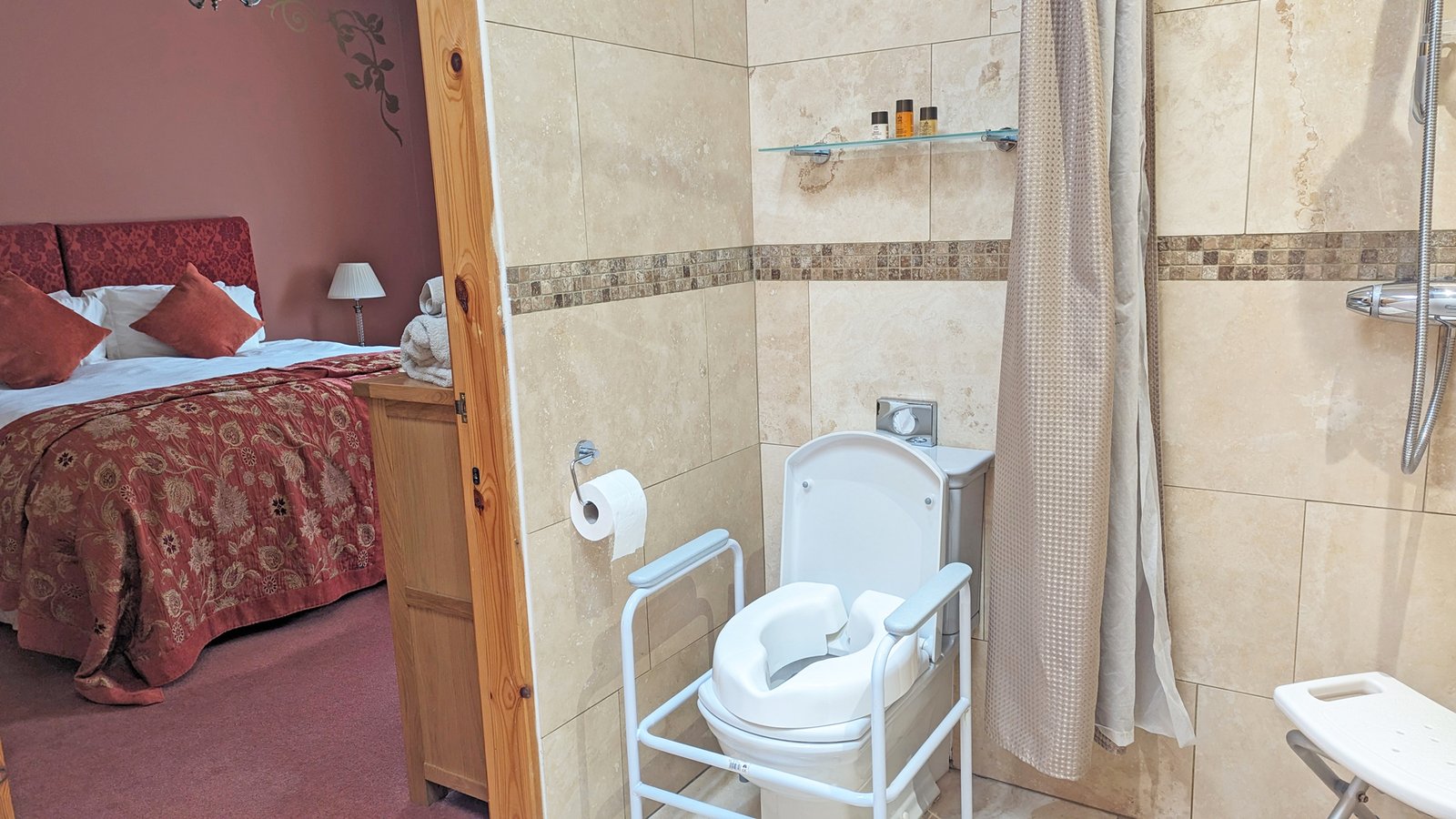 Accessible bathroom with adjoining bedroom view.