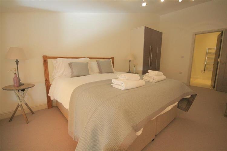 Cosy bedroom with double bed and soft lighting.